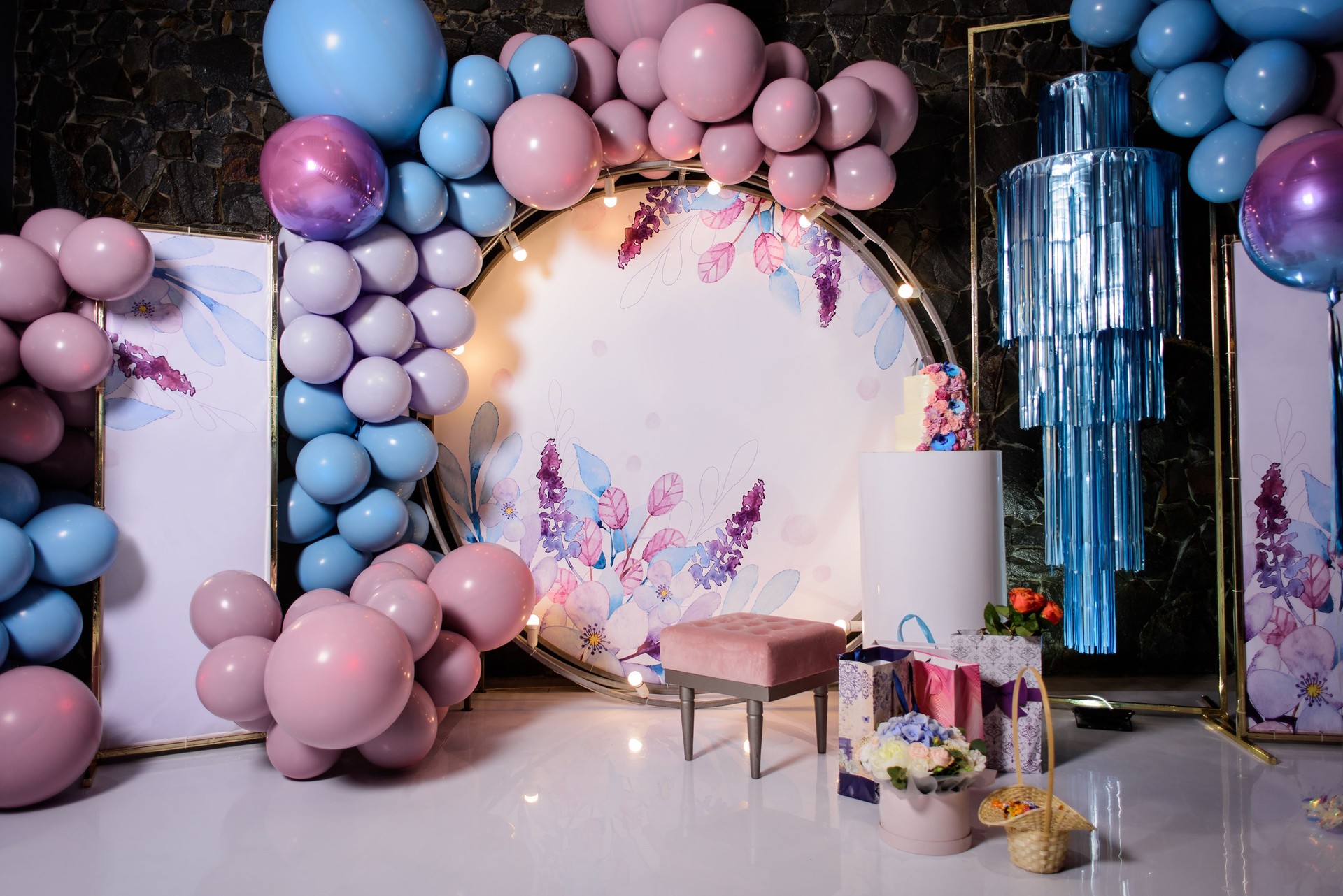 Photo zone with arch, balloons, flowers on birthday party